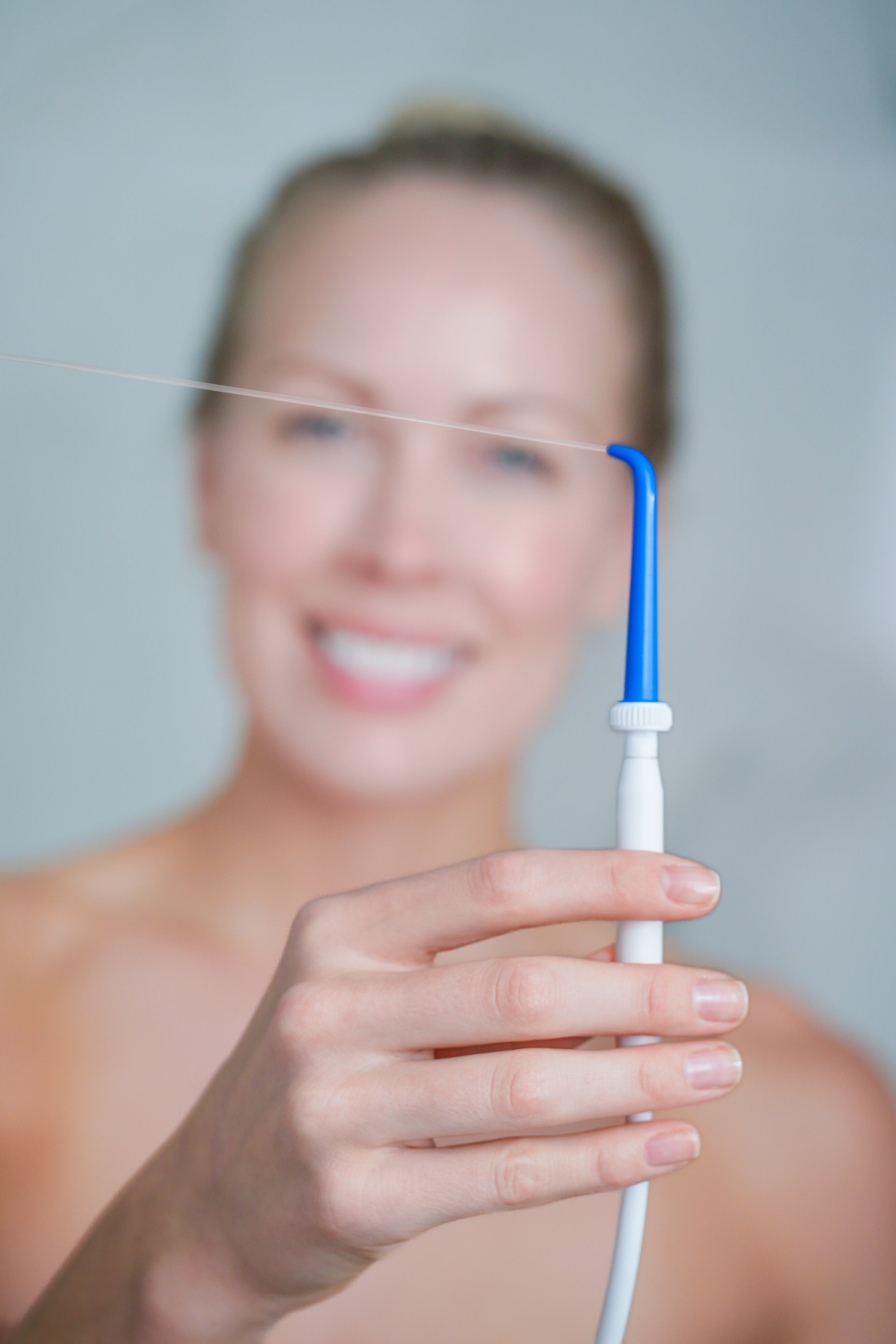 Woman using ShowerFloss in the shower