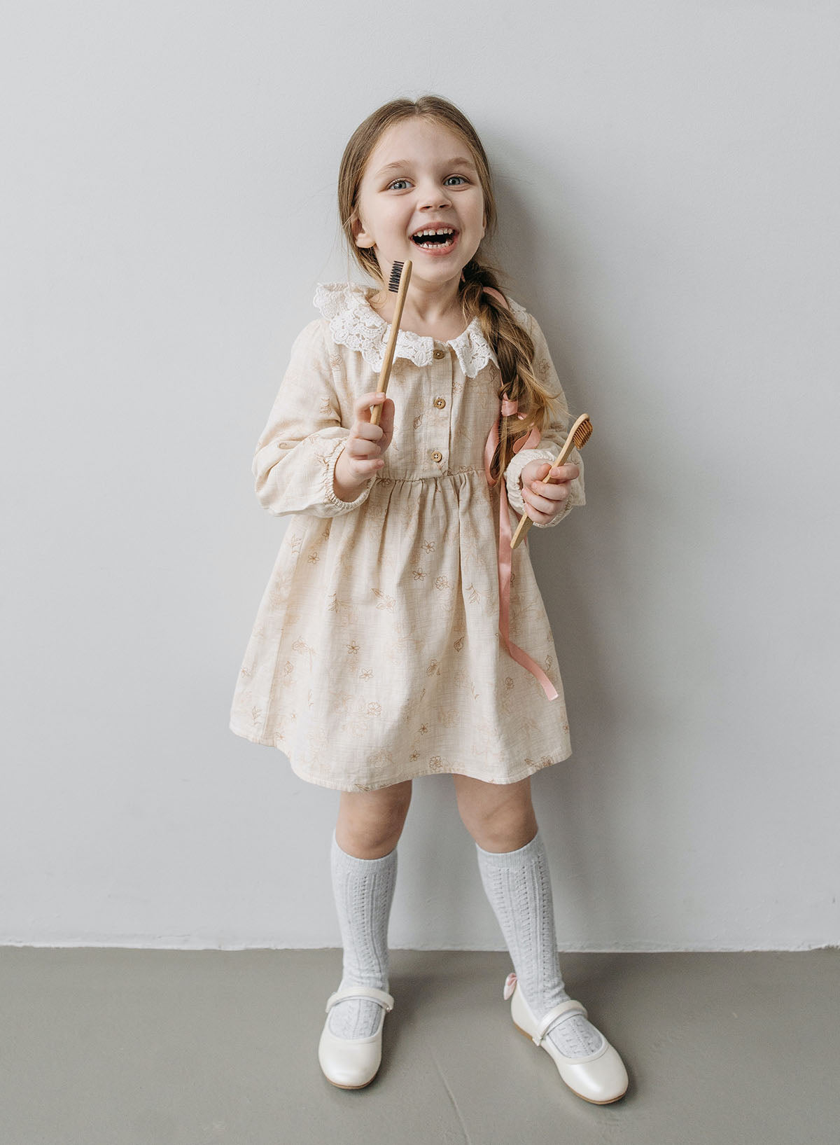 Smiling child holding toothbrushes